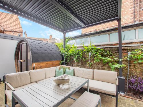 a patio with a couch and a table at Jorvik Villas in York