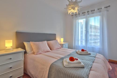a bedroom with a bed with two towels and a window at Golden Place Apartment in Funchal