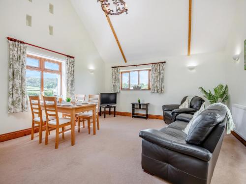 a living room with a couch and a table at Hayloft - Uk49909 in Blandford Forum