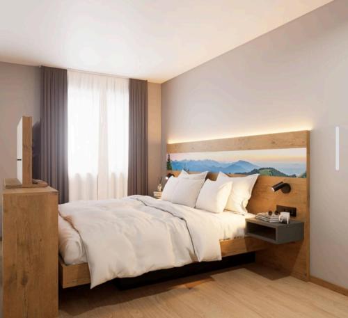 a bedroom with a large bed and a large window at Gästehaus Attenhauser in Unterammergau