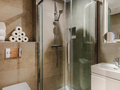 a bathroom with a shower and a toilet and a sink at Chi An Mor in Charlestown