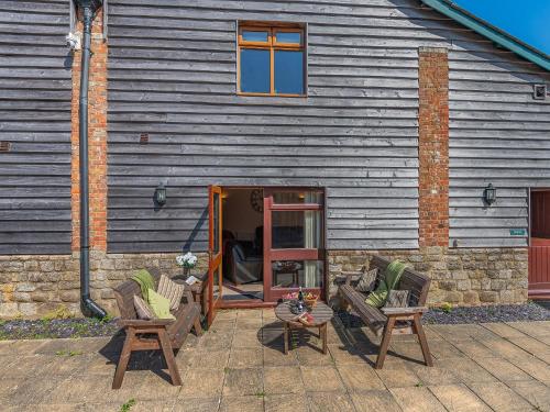 two chairs and a table in front of a building at Granary - Uk49910 in Blandford Forum
