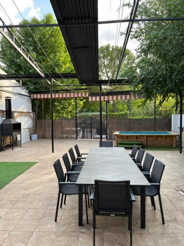 a large table and chairs in a patio at Casa Rural Abuelo Raimundo in Ossa de Montiel