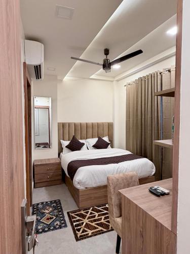 a bedroom with a bed and a table in it at 4 Seasons Residency in Katra