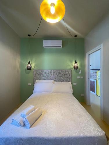a bedroom with a large bed with two towels on it at Riad Gilda in Torre Canne