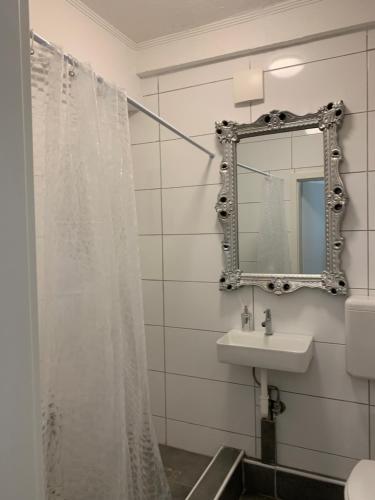 a bathroom with a shower curtain and a sink at Unterkunft Mara in Oberhausen