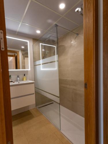 a glass shower in a bathroom with a sink at Calma Suite Apartment - Mar Menor Golf Resort in Torre-Pacheco
