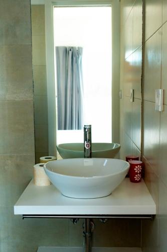 a bathroom with a white sink and a mirror at Baia Holiday Gardasee in Moniga