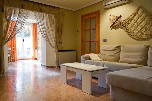 a living room with a couch and a table at Apartamento Plaza Mayor Trujillo in Trujillo