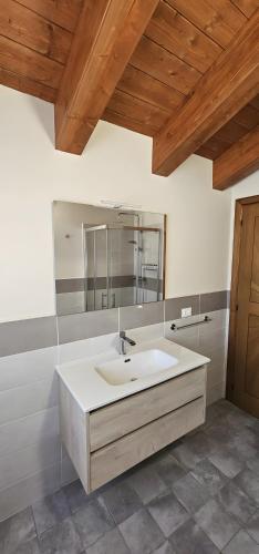 a bathroom with a white sink and a mirror at Casa Delia in Piazzano