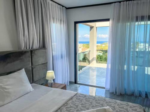 a bedroom with a bed and a large window at Suya Boutique Hotel in Kyrenia