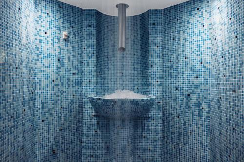 a blue tiled bathroom with a sink in it at Marine North Berwick in North Berwick