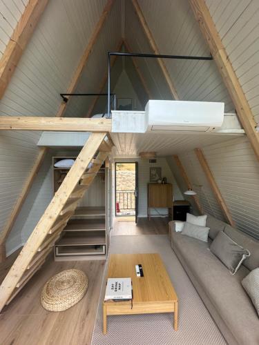 a living room with a couch and a loft at Serenity in Eşelniţa