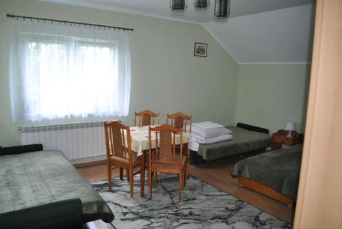 a room with a table and chairs and a window at Agroturystyka nad Sanem in Dydnia