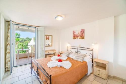 a bedroom with a bed with a bow on it at Anna Studios in Arillas