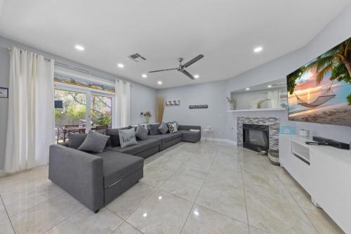a living room with a couch and a tv at Summerlin Private Buddha Estate Resort - Pool, Spa, Sauna, Game Room, Basket ball, Mini golf, Gym in Las Vegas