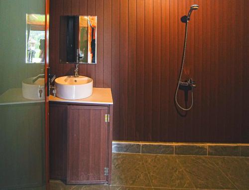 a bathroom with a sink and a shower at Leaf Village & Farm Làng Lá in Danang
