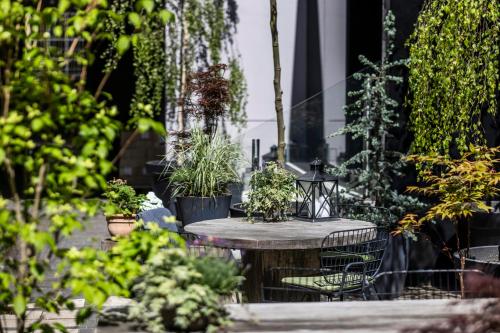 a patio with a table and potted plants at Motel One Copenhagen in Copenhagen
