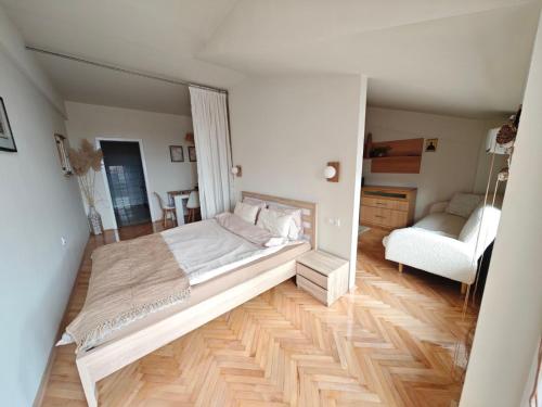 a bedroom with a large bed and a living room at Queen's Apartment Ohrid in Ohrid