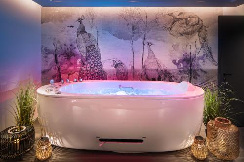 a bath tub in a room with a painting at Kamengrad Hotel & SPA in Panagyurishte