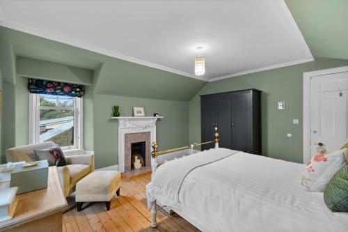 a bedroom with green walls and a bed and a fireplace at Hermitage Suite - Stylish Shared Accommodation in Dundee