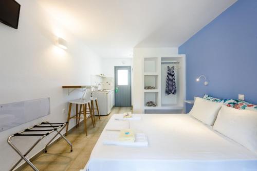 a living room with a white couch and a table at Anna Studios Paros in Naousa