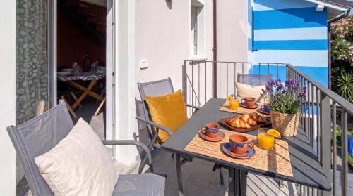 a table with a plate of food on a balcony at Casa Quadrifoglio - Ticino in Intra