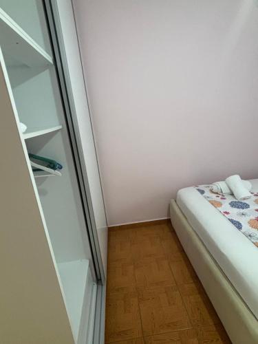 a small room with a bed and a closet at Borsh Beach Apartment in Borsh