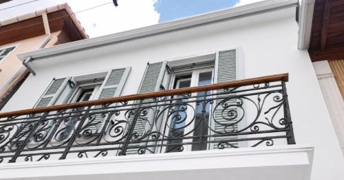 a balcony of a white building with windows at Lefkada Old Town Kantouni in Lefkada