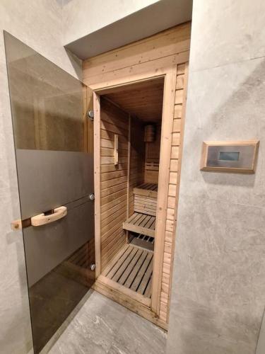 a small walk in closet with a wooden door at Roomy 1BR Balcony-40sqm-4px-PET-Parking-MOA,PICC,WTC,CCP in Manila