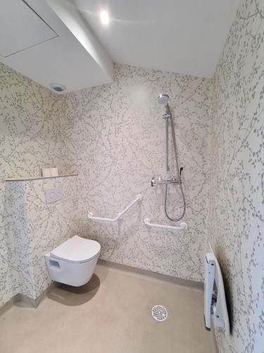 a bathroom with a toilet and a shower at La Noisette Basque - Nuits au verger in Saint-Pée-sur-Nivelle