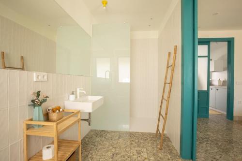 ein Badezimmer mit Waschbecken und Spiegel in der Unterkunft Raízes 22 - Apartamento 1 in Puebla de Don Fadrique