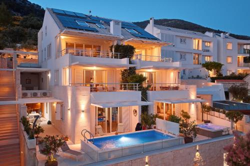 a villa with a swimming pool at night at Belado Residence Bol in Bol