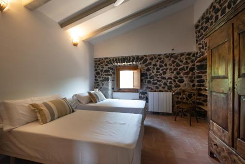 a living room with two beds and a couch at Can Quel in Canet de Adri