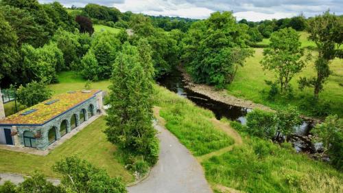 an aerial view of a building next to a river at The Old Poolhouse in Beetham