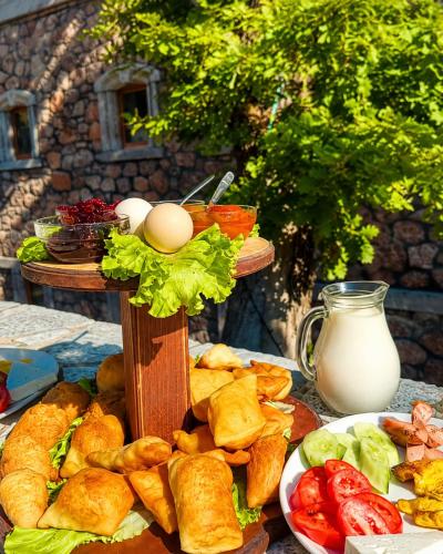a table with a plate of bread and eggs on it at Bujtina Çupa in Klos