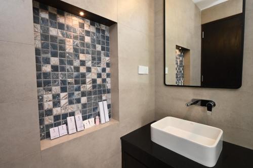 a bathroom with a sink and a mirror at Skyloft Kandy in Kandy