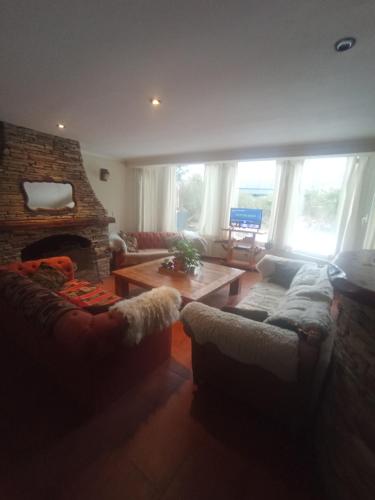 a living room with a couch and a fireplace at Las Asturianas in San Carlos de Bariloche