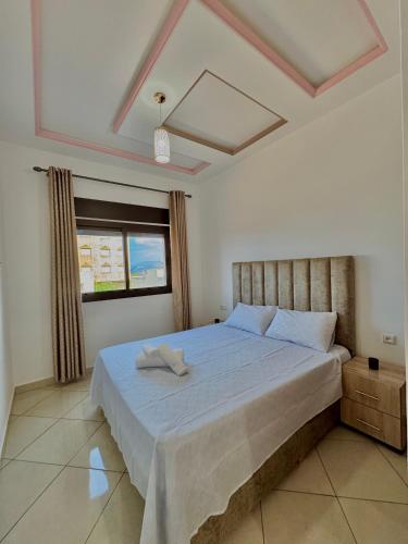 a bedroom with a large bed in a room at Paraiso Costero Azla Tetouan in Azla