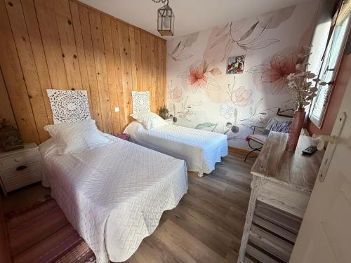 a bedroom with two beds and flowers on the wall at le Relais de la Cavayere - Chambres d'hôtes avec SPA & SAUNA Carcassonne - Parking privé ferme in Carcassonne
