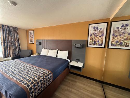 a hotel room with a bed and a window at Villa West Inn in Odessa