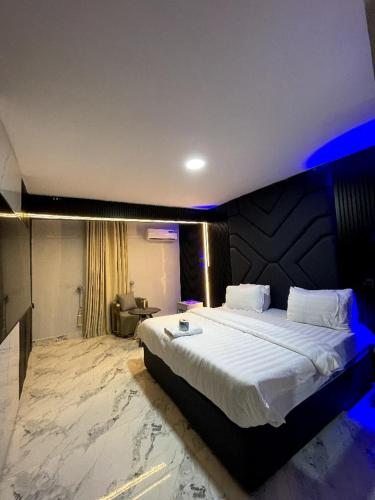 a bedroom with a large bed in a room at Kim Royal Hotel and Suites in Festac Town