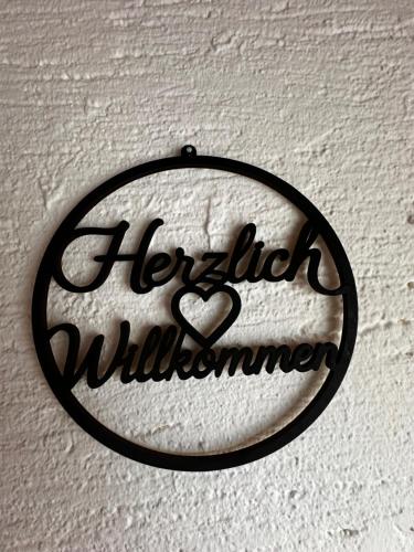a sign with the words hello wilderness hanging on a wall at Ferienhaus Ute in Irschen