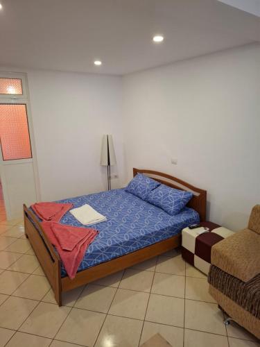 a bedroom with a bed and a lamp and a chair at Saranda porti in Sarandë