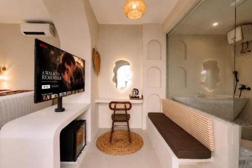 a living room with a tv and a fireplace at Maroko Jogja Villas With Privatepool in Ngaglik