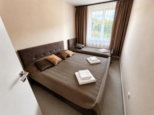 a bedroom with a large bed with two tables on it at Aparthotel Olympland in Trutnov