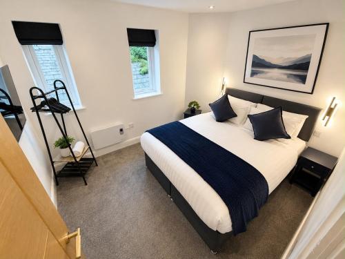 a bedroom with a large bed with pillows on it at Castle Chambers Serviced Apartments in Lancaster