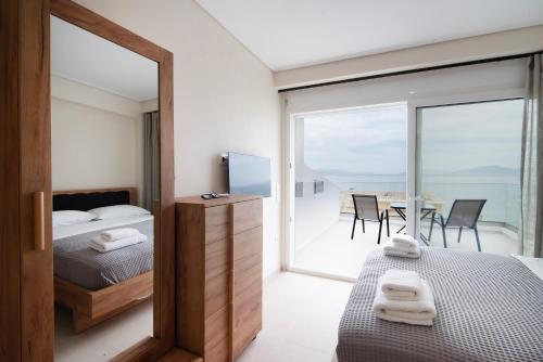 a bedroom with a bed and a table with chairs at Virea VA Complex in Vaia