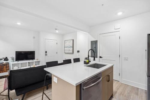 a white kitchen with a sink and a counter at Mary's Stay Brookland in Washington, D.C.