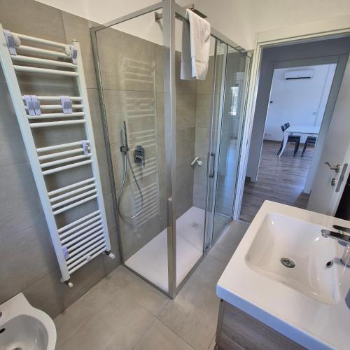 a bathroom with a shower and a sink at Appartamento Scossicci in Porto Recanati